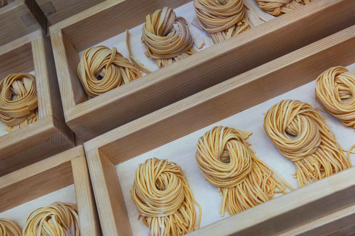 Small packets of fresh pasta in a wooden crate